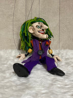The Joker marionette puppet with iconic white face paint and green hair