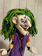 The Joker marionette showing detailed face makeup and maniacal smile - close up