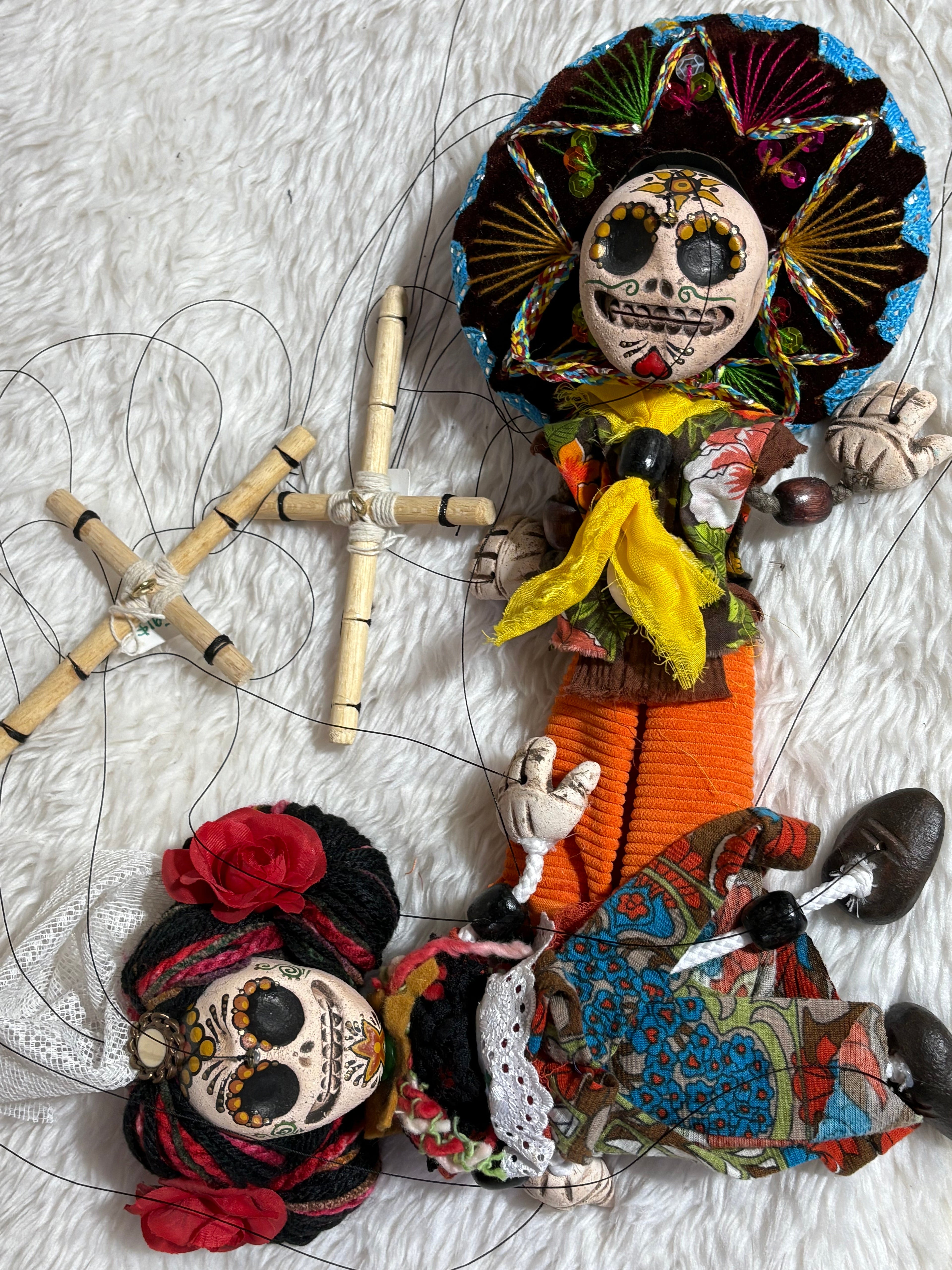 Colorful marionettes on a textured white surface